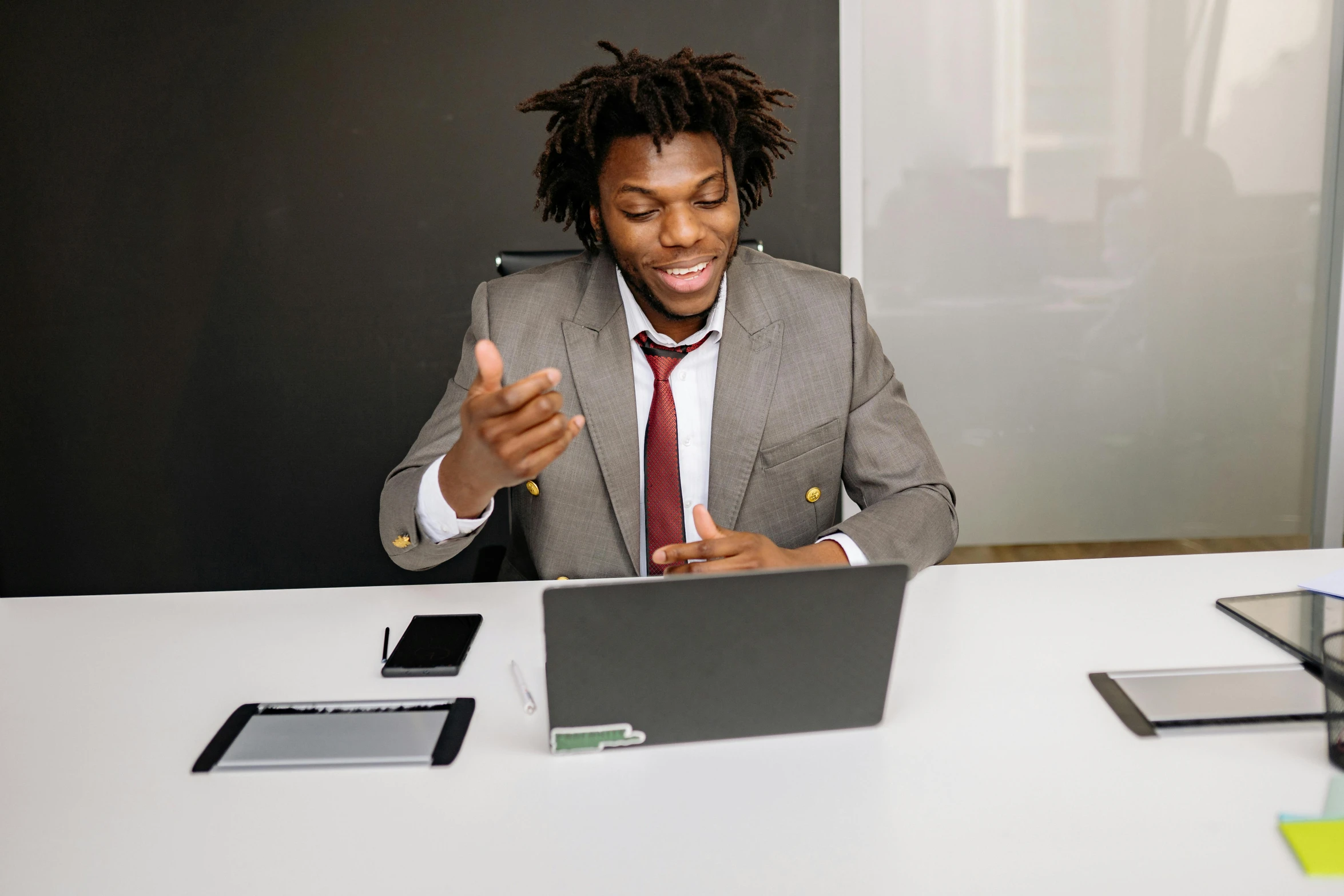 a person is in an office setting with his laptop and a phone