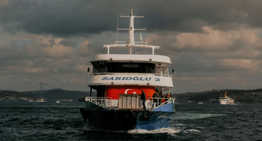 a large ship with an orange and blue front end