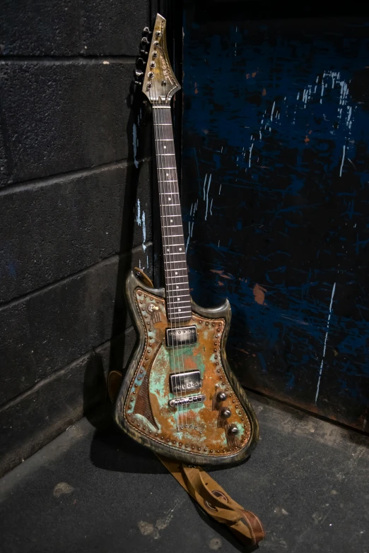 an old guitar with some faded paint on it