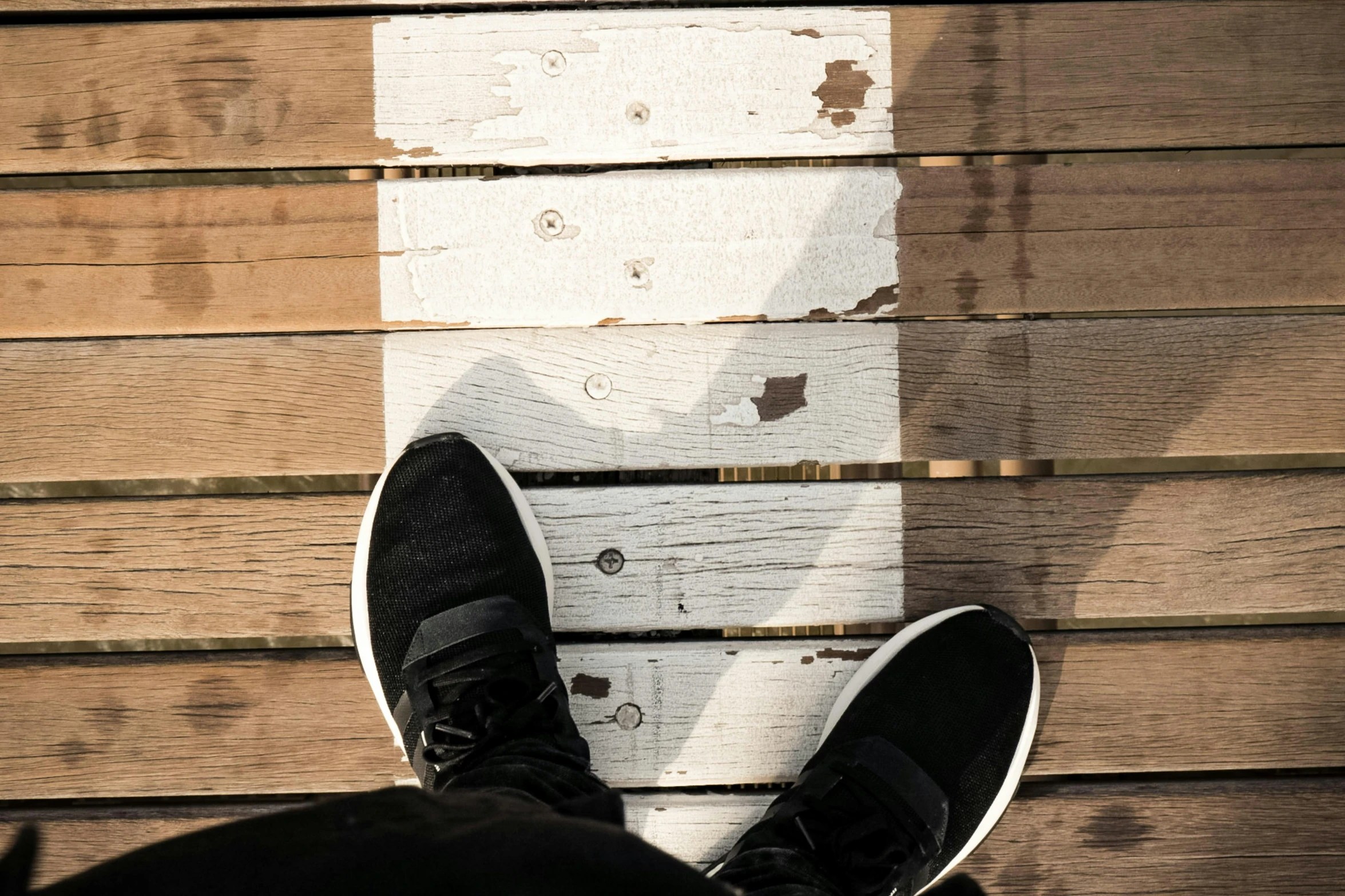 there is a person standing on top of a wooden deck