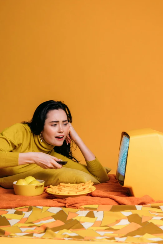 a woman is sitting down on a bed with food