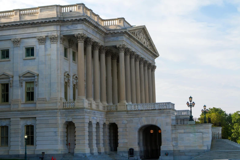 a white building with columns and two doors