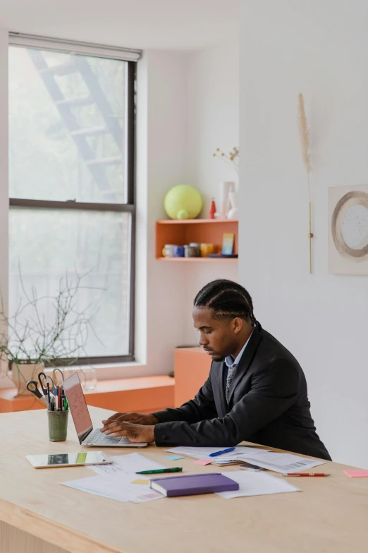 a man sitting at his desk working on a computer