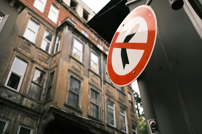 a close up of a road sign near a building