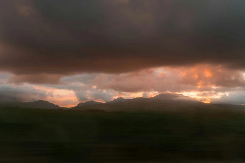 some clouds and a mountain under it