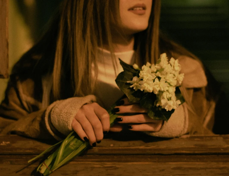the woman has long hair holding her bouquet