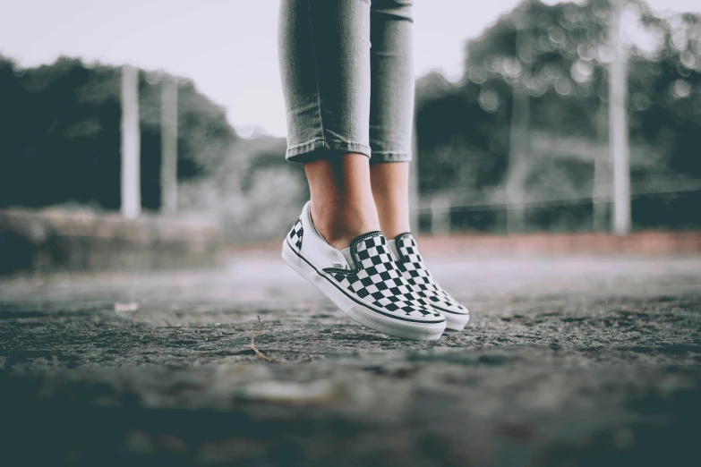 a woman in white and black checkered shoes