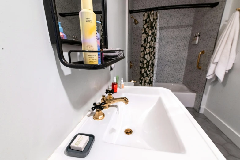 a bathroom sink sitting under a mirror in a bathroom