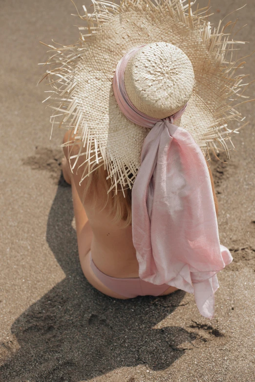 there is a small white hat on the back of a woman's head