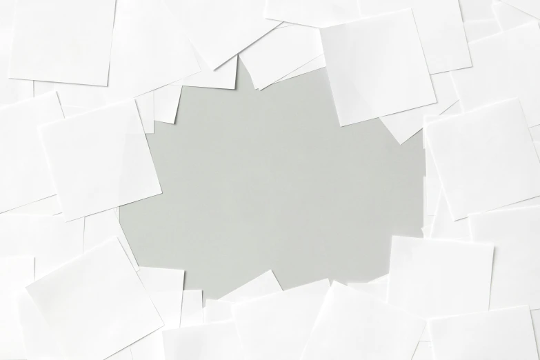 white paper squares are scattered about a light gray background