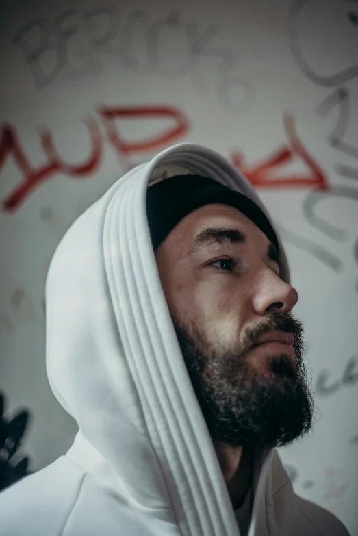 a bearded man with a hoodie on