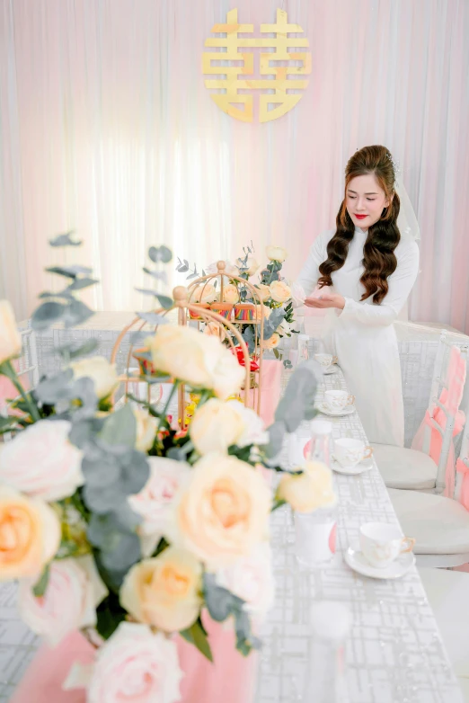 a girl sitting at a table in a room