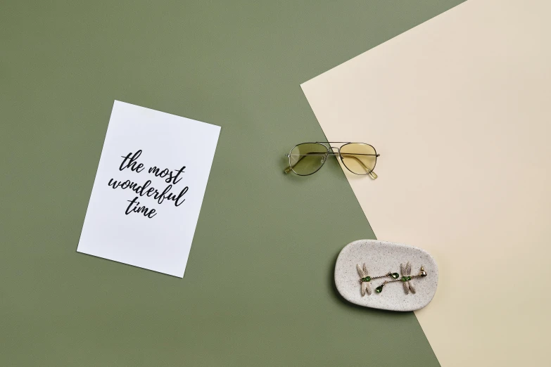 a pair of sunglasses next to a paper with a quote on it