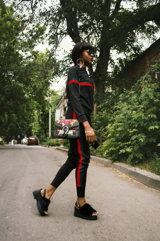 a  walking down the street carrying her purse