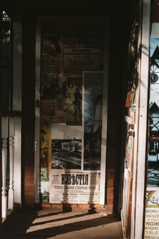 some newspaper papers on the side of a building