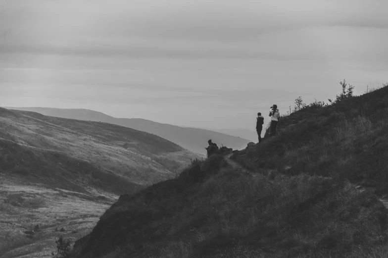 some people are standing on a hill top