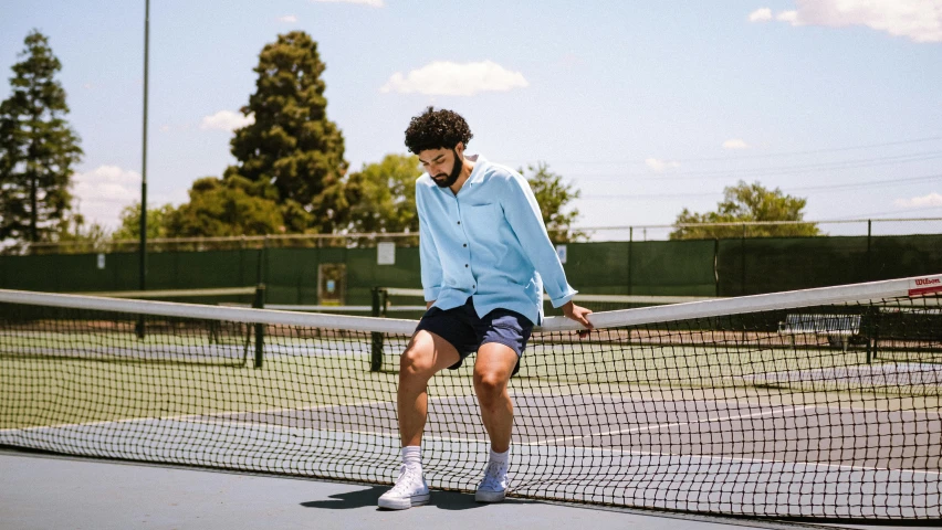 a man standing on top of a tennis court holding a racquet