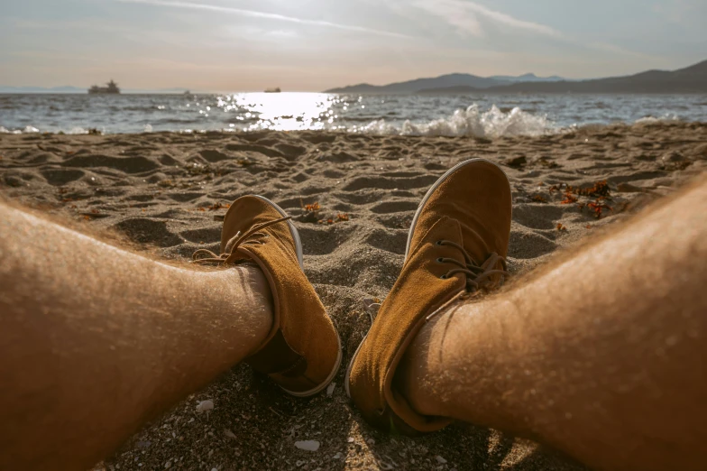 a person standing in front of the ocean on a beach