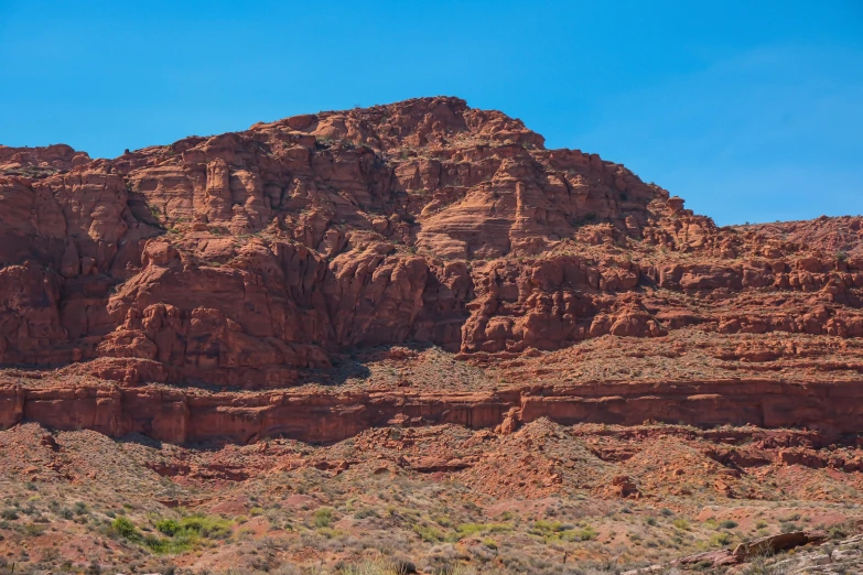 a mountain with a red rock formation in the background