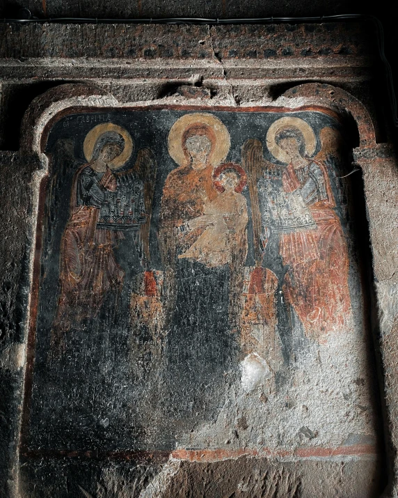 paintings on the wall of a house with black paint and rust