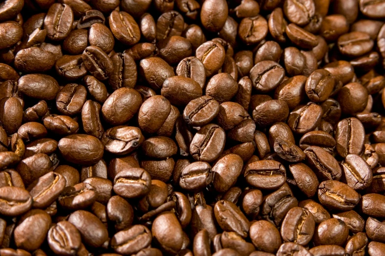 a brown and black pile of coffee beans