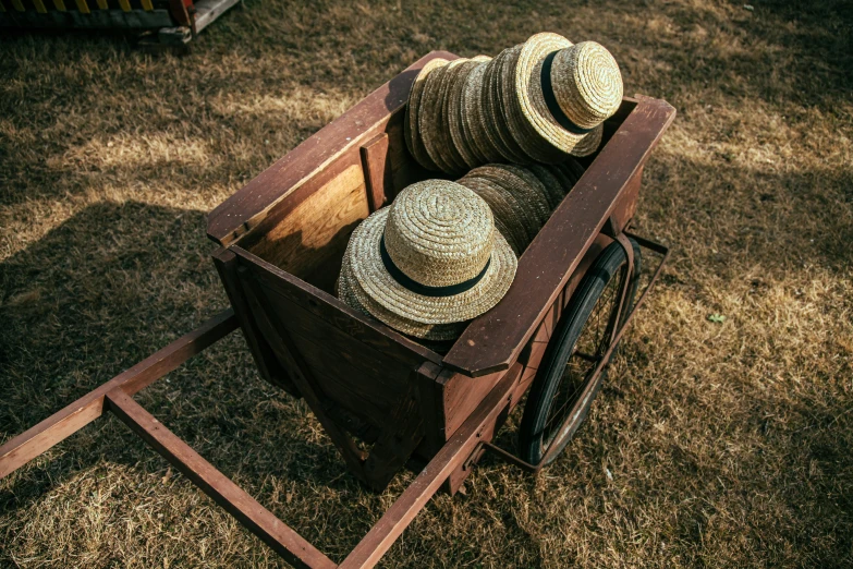 two hats are stacked up in a wagon