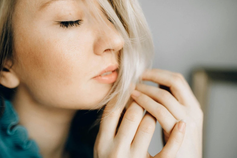 a blonde haired woman is posing for the camera