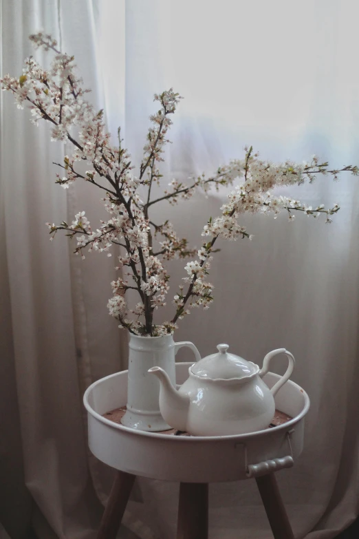 a teapot with a tea set next to it on a table