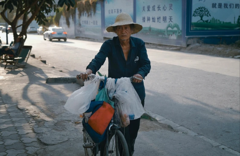 a man riding on the back of a bike down a street