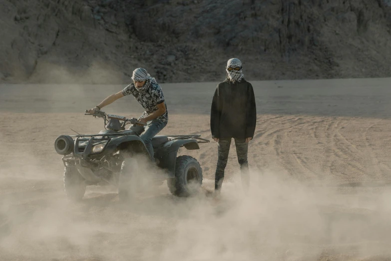 a man in a helmet is riding an atv on a foggy trail