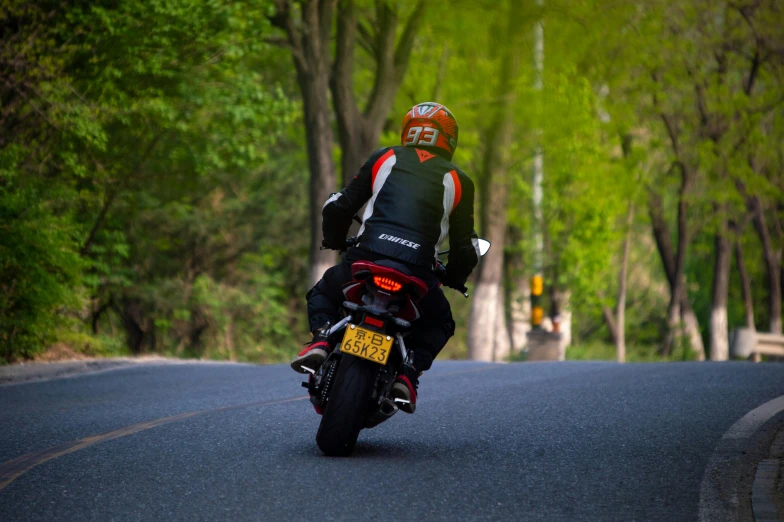 a person is riding a motorcycle down a country road