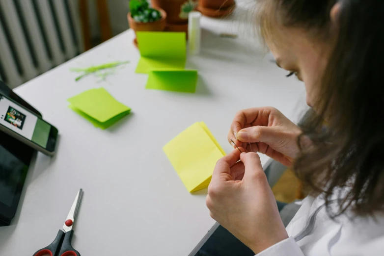 a woman who is holding up some post it notes