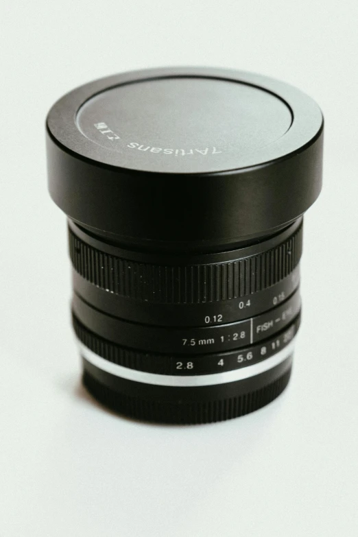 a lens on a white surface with a reflection