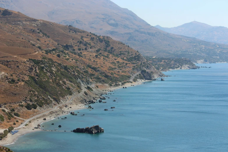 a body of water near mountains and boats