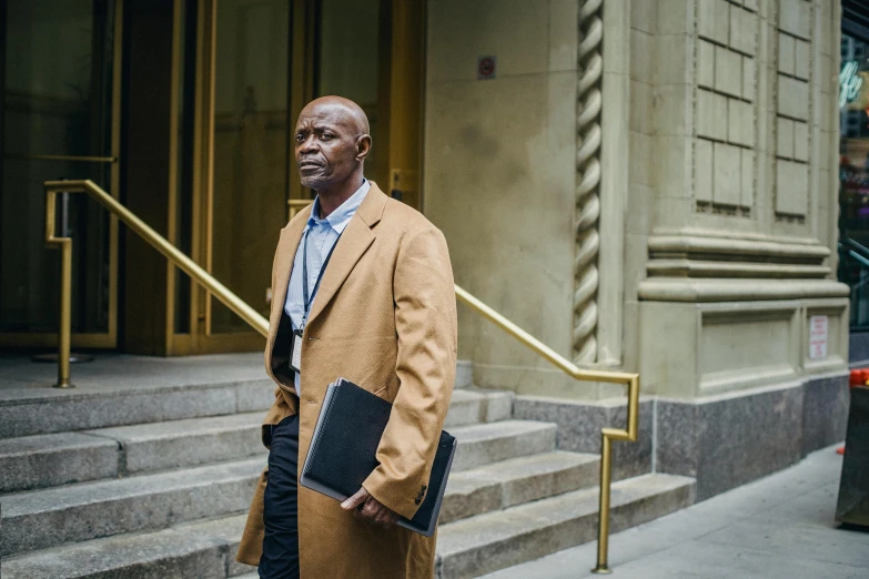 a man is standing outside on the stairs of an old building