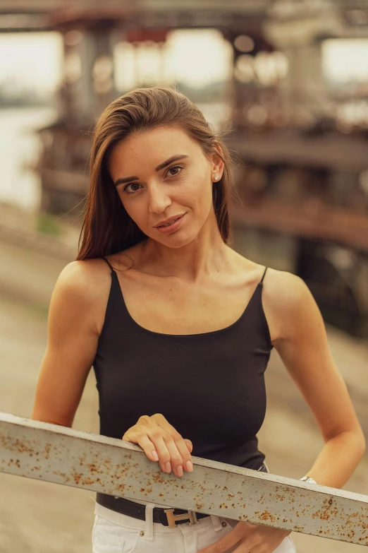 an attractive woman wearing a black top posing for the camera