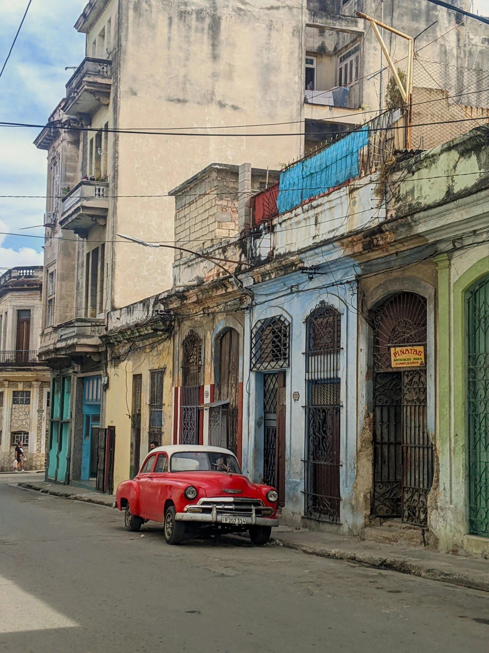 an old red car parked in front of a house