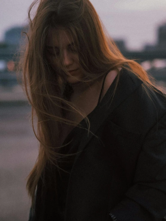 a woman with long hair looking at her cellphone