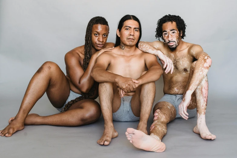 three men with hairy bodies are on the ground