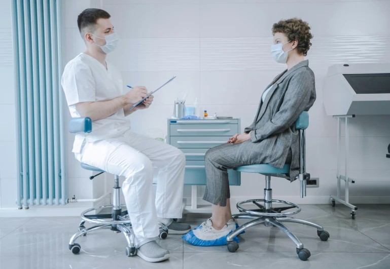 a woman sitting next to a man on top of a blue chair