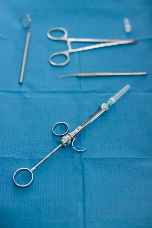 a surgical instrument lying on a sheet in order to help patients