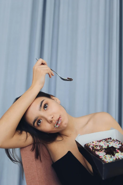 a woman is holding a fork up to her hair