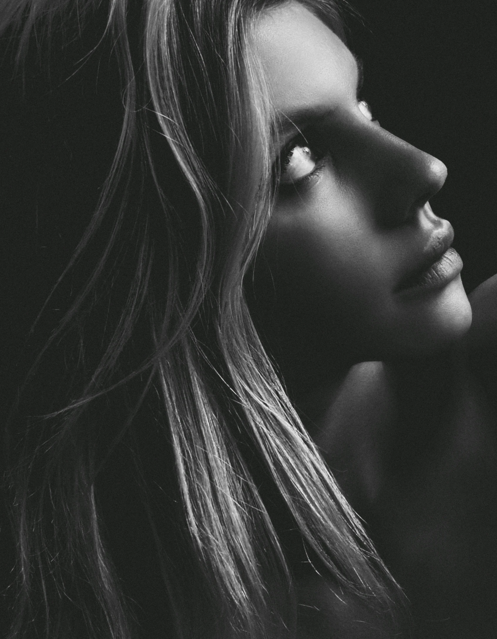 a black and white po of a girl with her long hair blowing