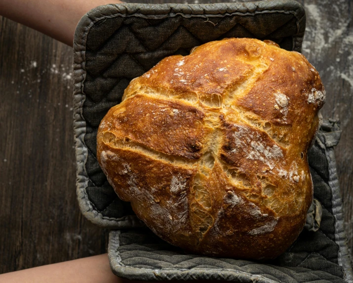 a large loaf of bread sits in a towel