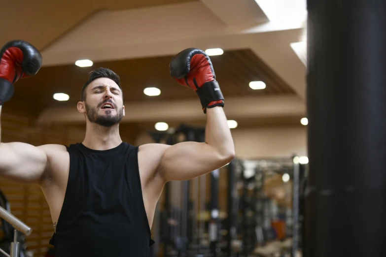 man with gloves on preparing for boxing in gym