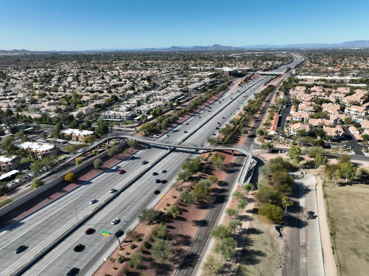 a road junction and freeway surrounded by land and buildings