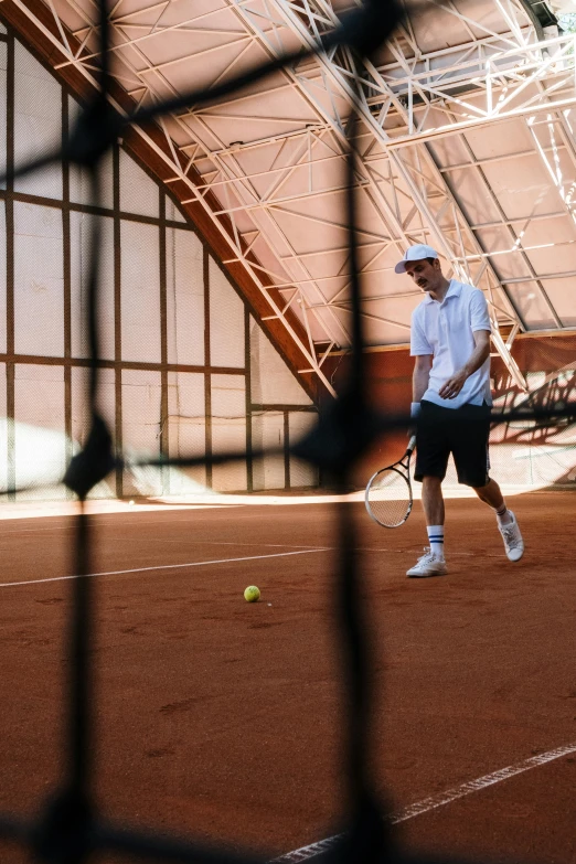 man holding a tennis racket on a court