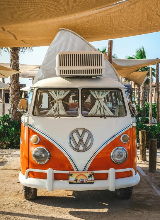 a camper van is parked outside on dirt