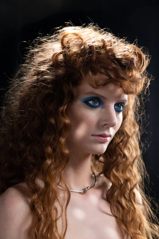 a close up of a very beautiful woman with long red hair