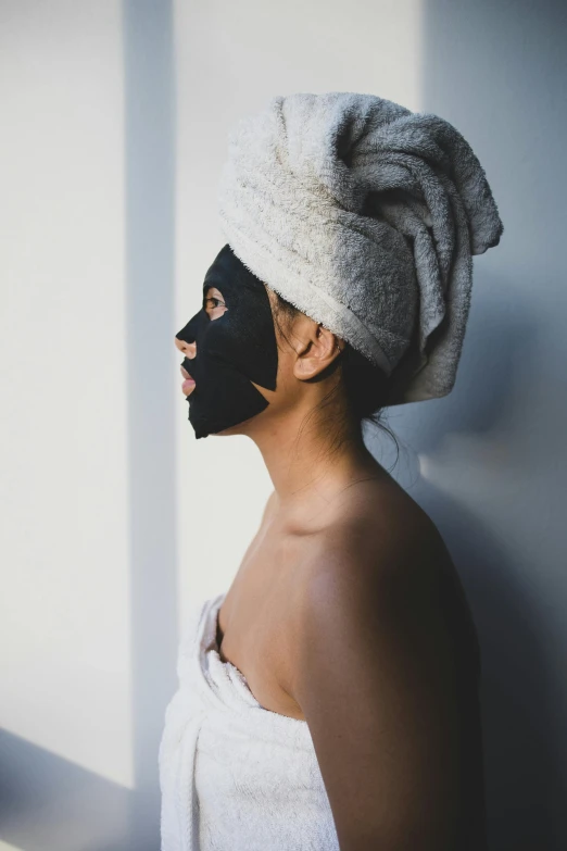 a woman in a towel with her face painted